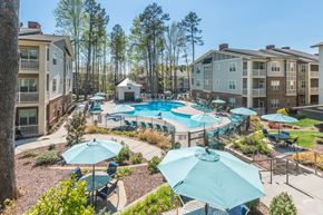 Indian Trail apartment for rent - Aerial view of the pool surrounded by lounge chairs at The Everlin at Indian Trail apartments in Indian Trail, NC.