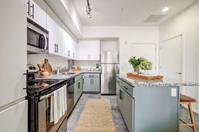 Phoenix apartment for rent - a modern kitchen with stainless steel appliances and gray counters