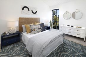 Alameda apartment for rent - a bedroom with a bed and two mirrors on the wall