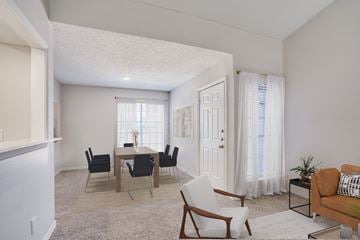 Carrollton apartment for rent - A living room with a dining table and chairs.