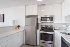San Francisco apartment for rent - a kitchen with white cabinets and stainless steel appliances