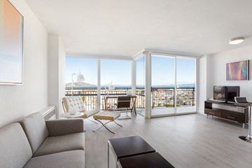San Francisco apartment for rent - a living room with a couch and a tv and a balcony