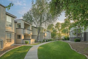 Professionally landscaped with trees throughout