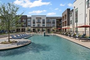 Hickory Creek apartment for rent - A swimming pool in front of apartment buildings.
