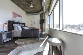Alexandria apartment for rent - A bedroom with a bed, a chair, and a rug.