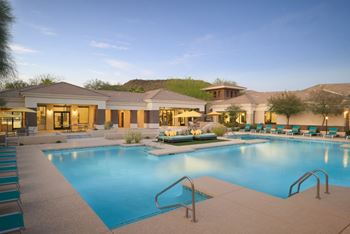 Resort style pool with relaxing loungers and day beds