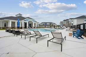 Columbia apartment for rent - A poolside area with chairs and umbrellas.