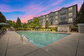 Charlotte apartment for rent - a swimming pool with an apartment building in the background