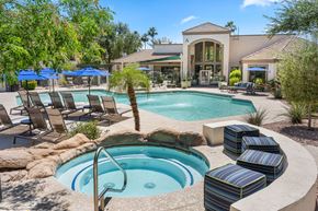 Tempe apartment for rent - A pool with a hot tub in the middle of it.