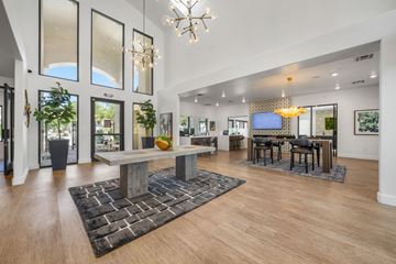 Tempe apartment for rent - A modern living room with a large wooden table and a chandelier.