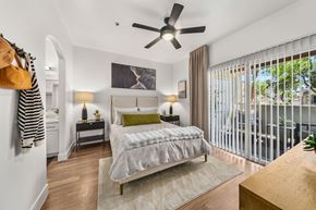 Tempe apartment for rent - A bedroom with a large bed and a ceiling fan.