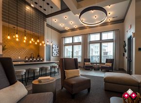 Lebanon apartment for rent - a lounge area with couches chairs and a bar and large windows