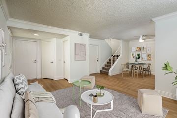 Ontario apartment for rent - A living room with a grey couch and a white coffee table.