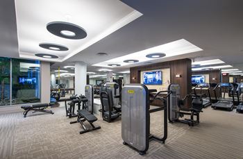 24-Hour fitness center with technogym cardio and strength equipment and yoga stretch space