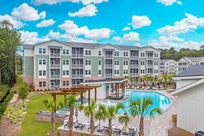 Savannah apartment for rent - Aerial view of pool and buildings at Waterleaf at Salt Creek luxury apartments in Savannah, GA.