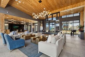 Hickory Creek apartment for rent - A modern living room with a wooden ceiling and a large window.