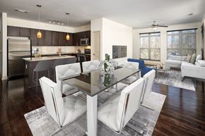 Brookhaven apartment for rent - a living room and dining room with white chairs and a glass table