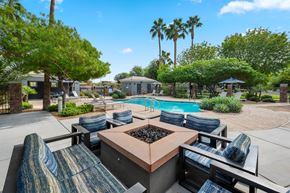 Phoenix apartment for rent - a patio with a table and chairs and a swimming pool