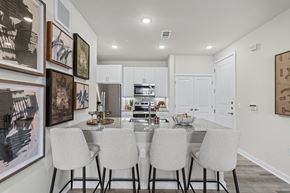Denton apartment for rent - A modern kitchen with a dining table set for four.