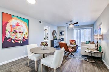 Mesa apartment for rent - a living room with a table and chairs and a ceiling fan