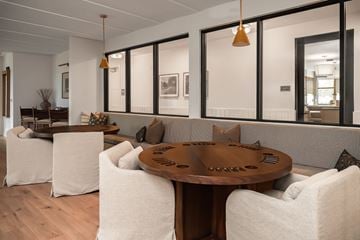 Austin apartment for rent - A modern living room with a wooden table and white chairs.