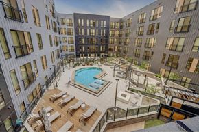 Salt Lake City apartment for rent - Aerial view of a resort-style pool with lounge areas at Luma new Salt Lake City apartments.