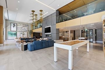San Diego apartment for rent - A modern living room with a blue sofa and a wooden coffee table.
