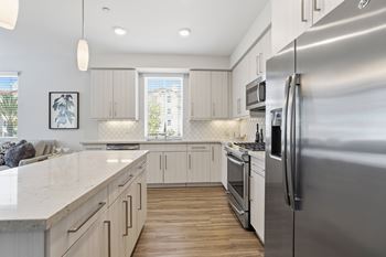 Gourmet kitchens with quartz countertops and soft-closing european-style cabinetry