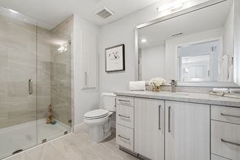 Designer bathrooms with tile surround and oversized soaking tubs in select units