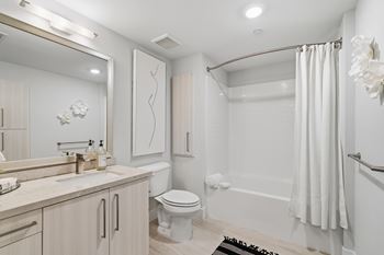Designer bathrooms with tile surround and oversized soaking tubs in select units