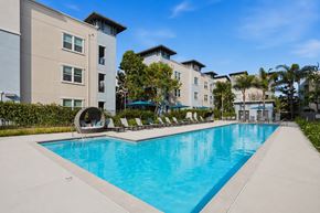San Marcos apartment for rent - A swimming pool in front of apartment buildings.