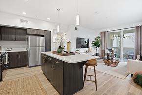 San Marcos apartment for rent - A modern kitchen with dark wood cabinets and a white island.