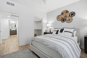 San Marcos apartment for rent - A bedroom with a large bed and a mirror on the wall.