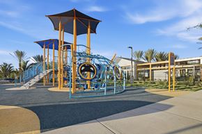Chula Vista apartment for rent - A playground with a blue and yellow slide and a brown and blue play structure.