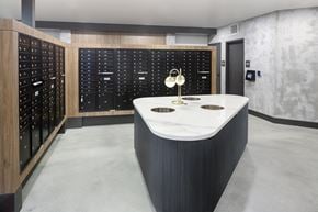 Anaheim apartment for rent - A modern kitchen with a marble countertop and a black cabinet with white handles.
