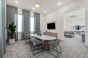 Denton apartment for rent - A modern dining room with a large table and grey chairs.