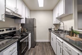 Martinez apartment for rent - A modern kitchen with stainless steel appliances and white cabinets.