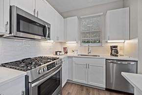 Charlotte apartment for rent - a kitchen with white cabinets and stainless steel appliances