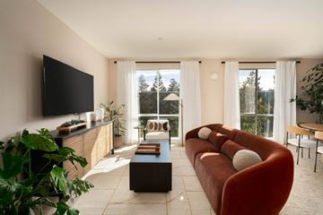 San Jose apartment for rent - A living room with a red couch and a flat screen TV.
