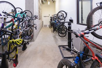 A bike rack full of bikes in a hallway.