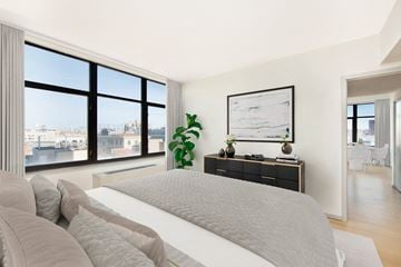 Brooklyn apartment for rent - A bedroom with a large bed and a view of the city.
