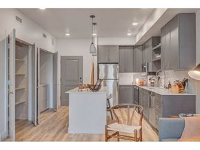 South Salt Lake City apartment for rent - a kitchen with a table and a chair and a refrigerator
