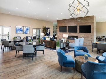 Chula Vista apartment for rent - a living room with blue chairs and tables and a fireplace