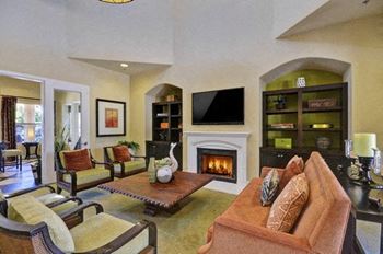 A living room with a fireplace and a television.