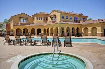 A large house with a pool in front.