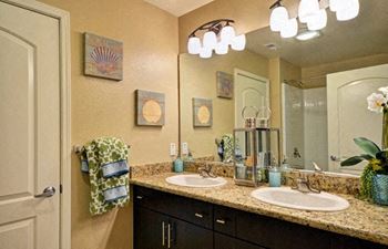 A bathroom with two sinks and a mirror.