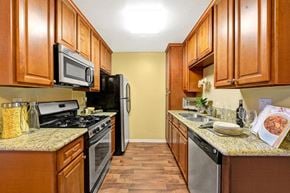 Chula Vista apartment for rent - A kitchen with wooden cabinets and a granite countertop.