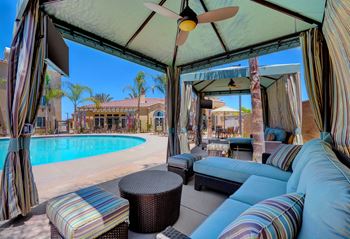 Shimmering heated pool with cabanas