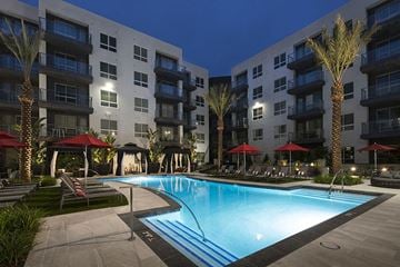 San Diego apartment for rent - a swimming pool in front of an apartment building at night