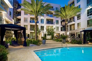Resort-like grand courtyard with outdoor pool, in-pool chaise lounges and areas for sunning